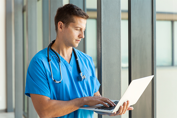 Nurse typing on laptop