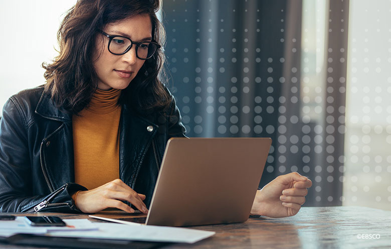 Woman sitting at a desk using a laptop