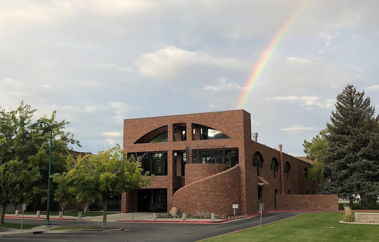 Opem Public Library building with a rainbow over it