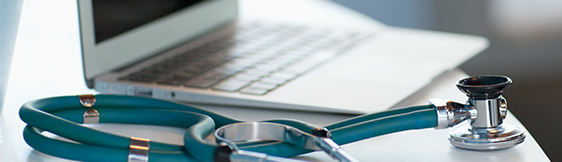 Close up of stethoscope and laptop