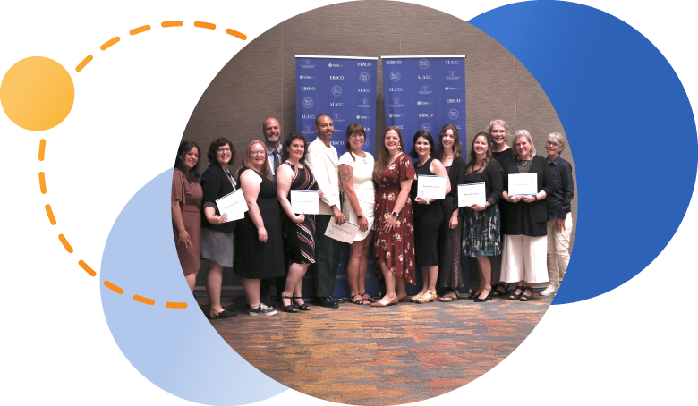 John Cotton Dana Awards winners posing in front of banner stands, holding certificates. 