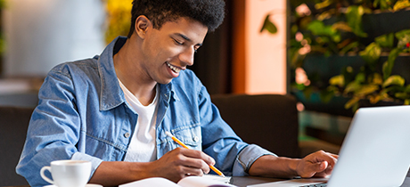 Male student working on laptop