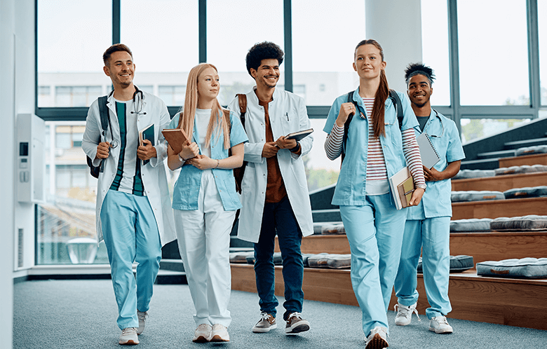 Five biomedical students walking through a lecture hall