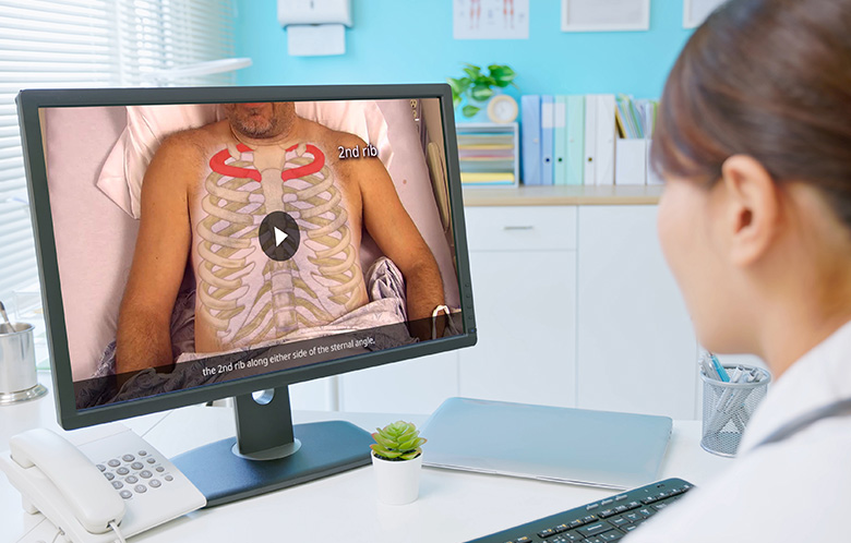 Doctor watching medical video on desktop