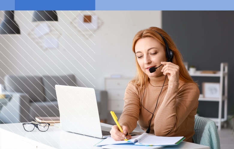 adult female working from home, on the phone, writing notes down on a notepad