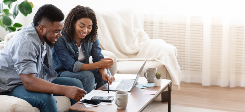 Two people financial planning on a laptop