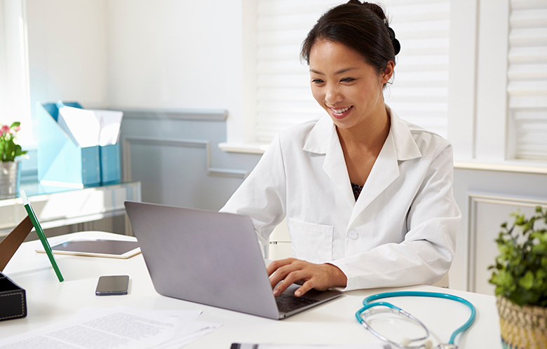 Doctor working on laptop in office