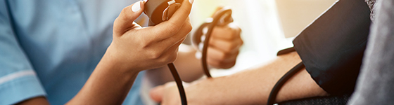 Close up of nurse testing patient's blood pressure