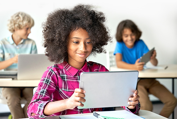 Young student on tablet in classroom